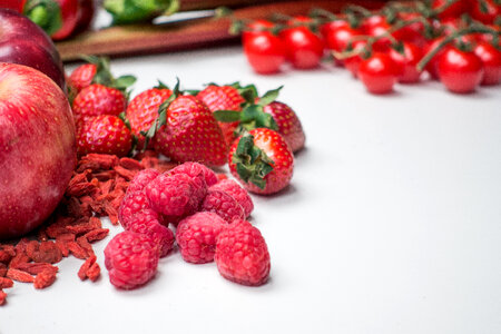 Fresh raspberries with other red fruit and vegetables photo