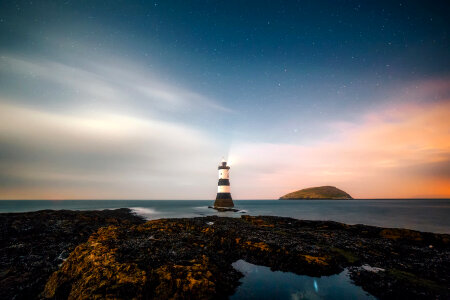Lighthouse and landscape under the stars photo