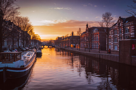 Houses and Boats near Amsterdam Canal at Sunrise photo