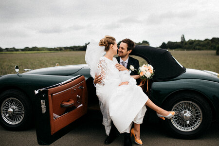 Just Married Couple Together in Black Vintage Car photo