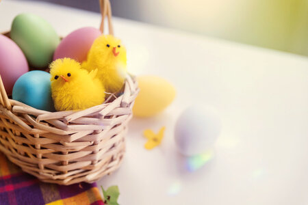 Happy Easter! Toy chicken and eggs in the basket photo