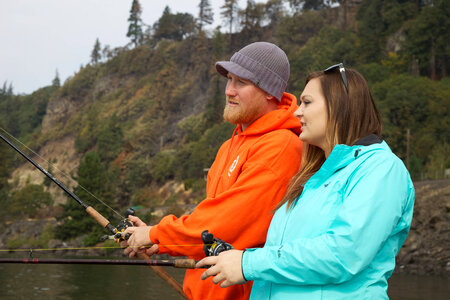 Young couple fishes for Fall Salmon