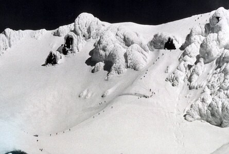 Snow capped peak with climbers on Mount Hood photo