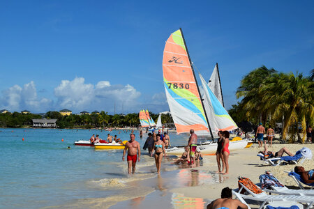 Colorful kayaks and sailing boats on a tropical beach in Cuba photo