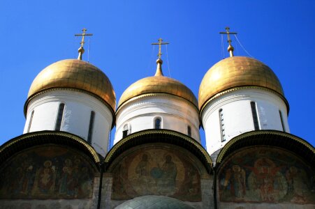 Three white towers onion domes golden photo