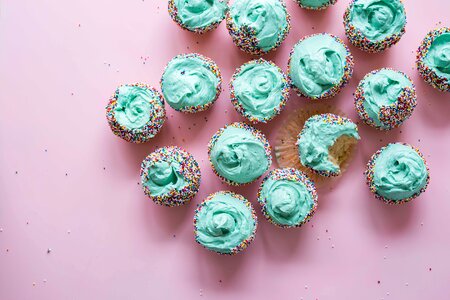 Cupcake with Mint Cream on Pink Background photo