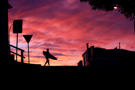 Silhouette of a Surfer against a Sunset Sky photo