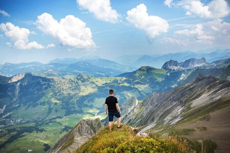 Man standing on the Alps at Interlaken, Switzerland photo