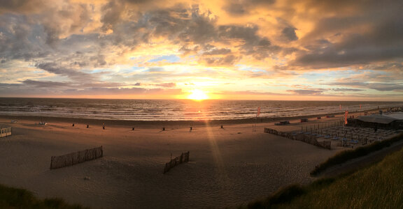 Sunset on the beach with clouds photo