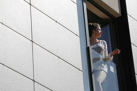 Window young woman cigarette photo