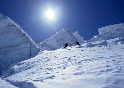 Full length of skier skiing on fresh powder snow photo