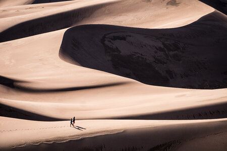 Couple Walking Through the Sand Dunes photo