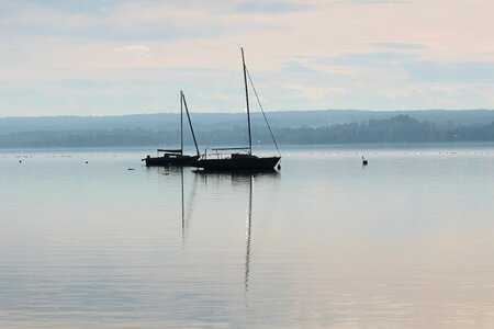 Lake sailing boat mirroring photo
