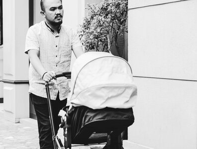 Father Walking with Baby in Stroller photo