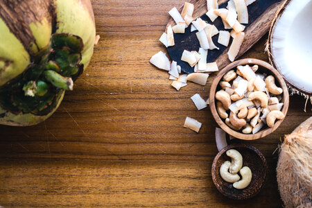 Cashew nuts and coconut on a wooden table photo