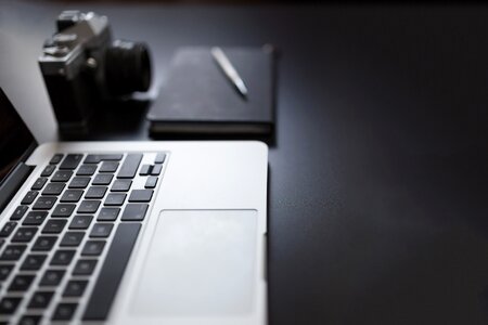 MacBook, Camera and Notepad photo