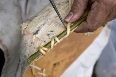Woman working on a craft at Tetlin Service employee showing Native American crafts at Tetlin National Wildlife Refuge