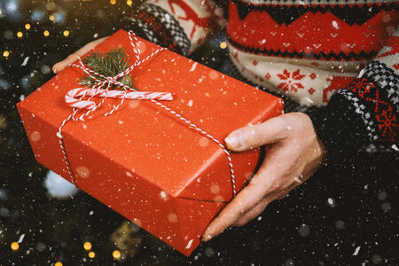 2 Man’s hands hold christmas gift box. Merry Christmas photo