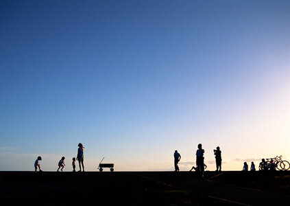 Group of people on sunset beach photo