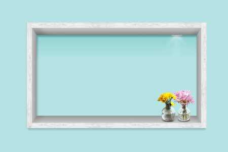 white frame with flower on the blue wall photo