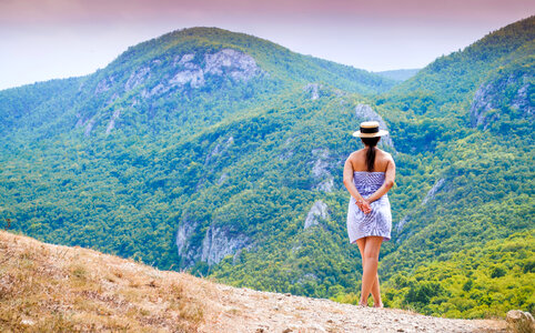 Girl looking at mountains landscape