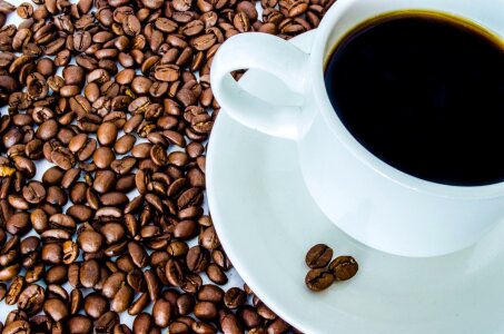 Cup of black coffee and coffee beans photo