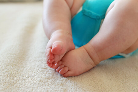 The newborn and his little feet on a blanket photo