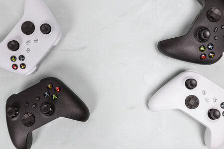 Gaming concept. White and black joysticks on white background. photo