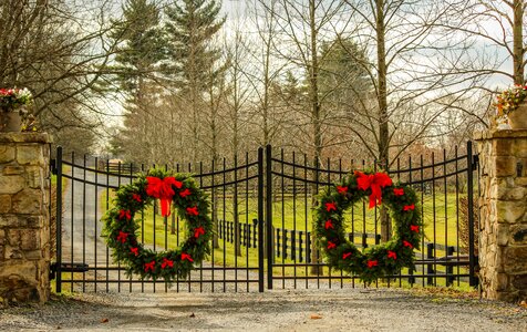 Red bows wrought iron gates stone pillars photo