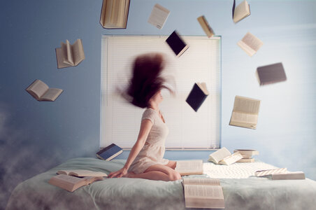 Young women Madness, Flying Books over the Bed photo
