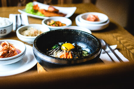 Traditional Korean Bibimbap vegetables with raw egg yolk photo