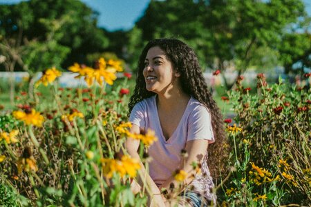 Beautiful young woman in rose garden