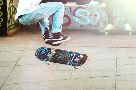 Skateboarder doing a trick in a skate park photo