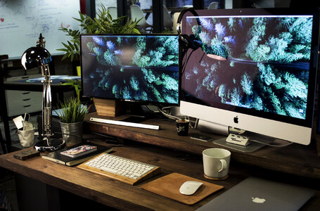 Computer nad Monitor on Cozy Dark Wooden Table photo