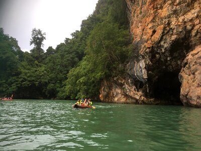 Tourists kayaking through limestone cliffs in Phang-nga Bay photo