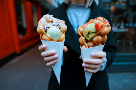 Woman Standing with Delicious Ice Creams in her Hands photo