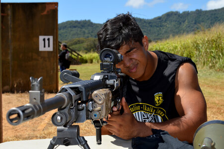 Man looking through the scope on a sniper gun photo
