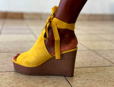 Woman foot yellow shoe photo