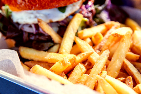 Detail of fries with hamburger at restaurant photo