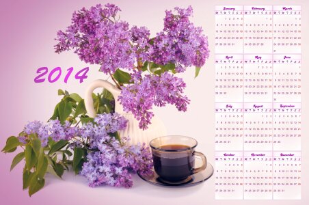Calendar for 2014 with a bouquet of lilacs and a cup of coffee photo