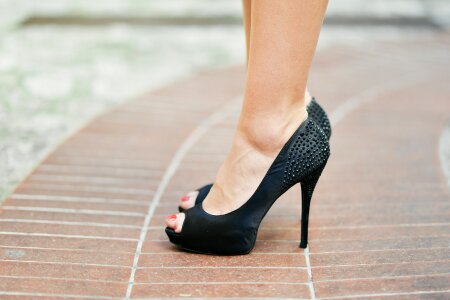 legs with black high-heeled shoes