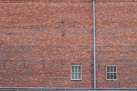 Old Wall Made of Red Brick with Two Windows photo