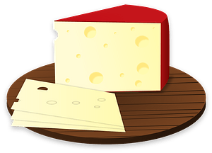 Cheese Wedge and Slices on a Round Cutting Board