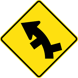 (W2-11) Staggered side road intersection, first from right on a curve on left