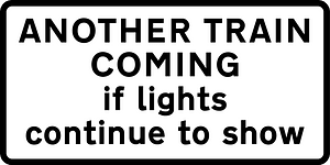 Supplementary plate at multiple track automatic level crossings warning of a second train