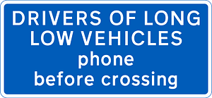 Information sign for large vehicles informing to phone at automatic level crossing