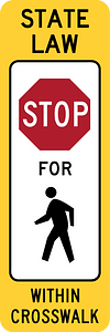 R1-6a: In-Street Ped Crossing (The legend STATE LAW is optional. A fluorescent yellow-green color may be used instead of yellow for this sign.)