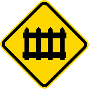 Level railroad crossing with barriers ahead sign in Brazil