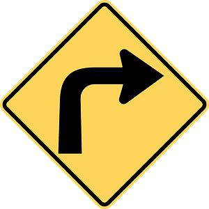 Sharp curve ahead sign in British Columbia