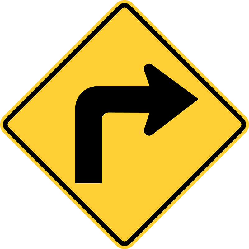 Sharp curve ahead sign in Canada